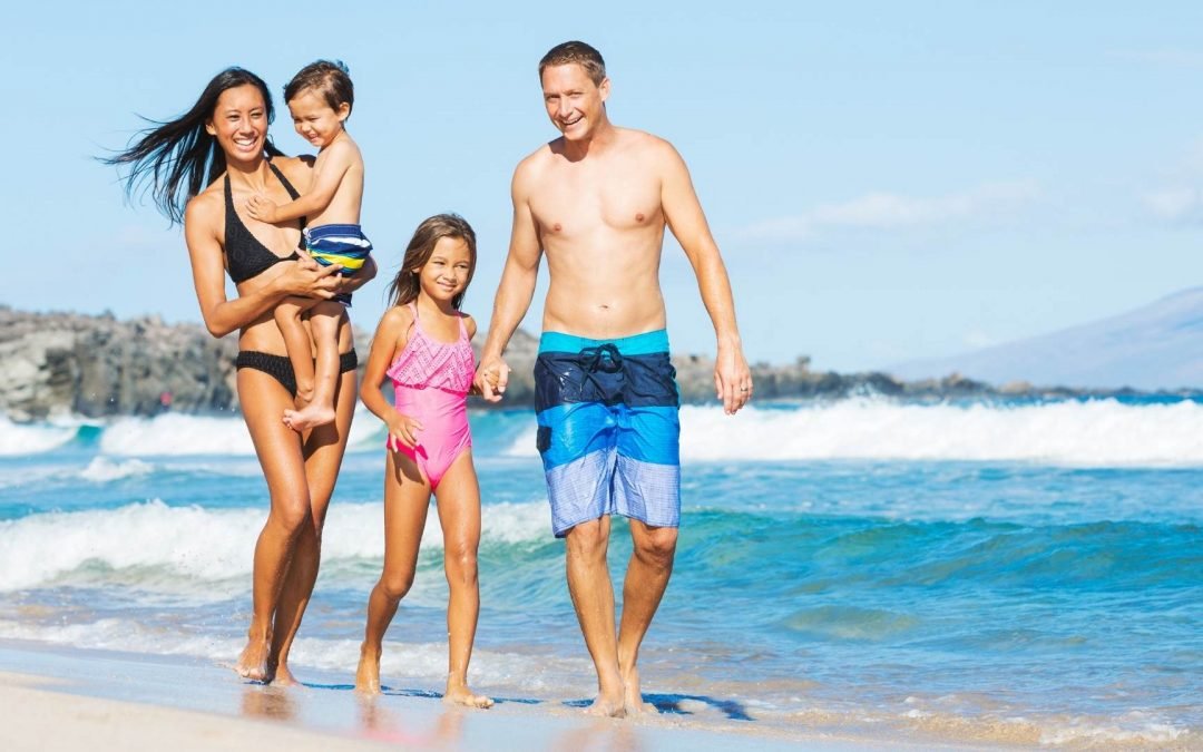 image showing family on beach nhs travel vaccines