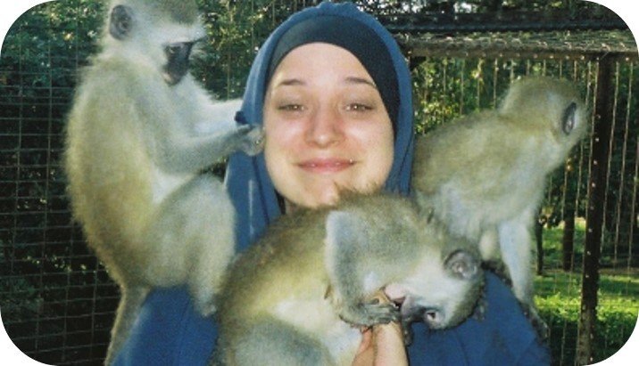 Picture of me in South Africa covered in monkeys illustrating the potential need for rabies vaccines 