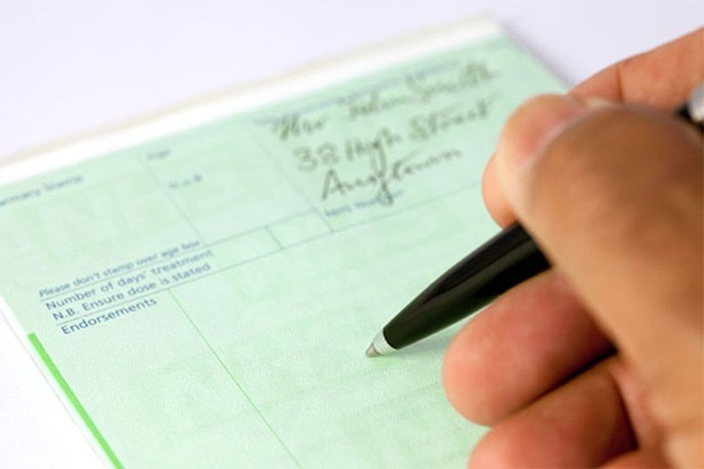 Image showing a Clinician writing an FP10 prescription