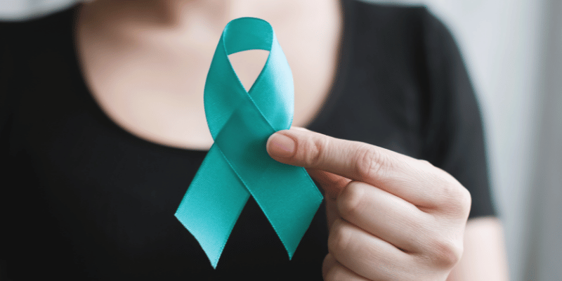 Image showing a women holding a teal ribbon for cervical cancer