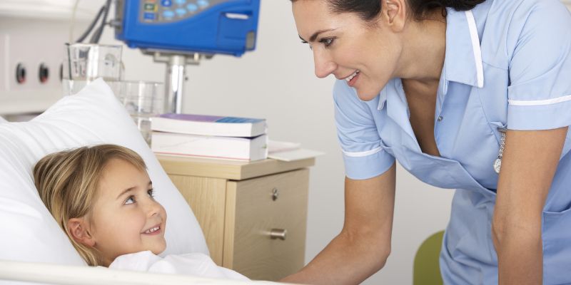 Image showing a nurse carrying out an assessment of a child in a primary care setting