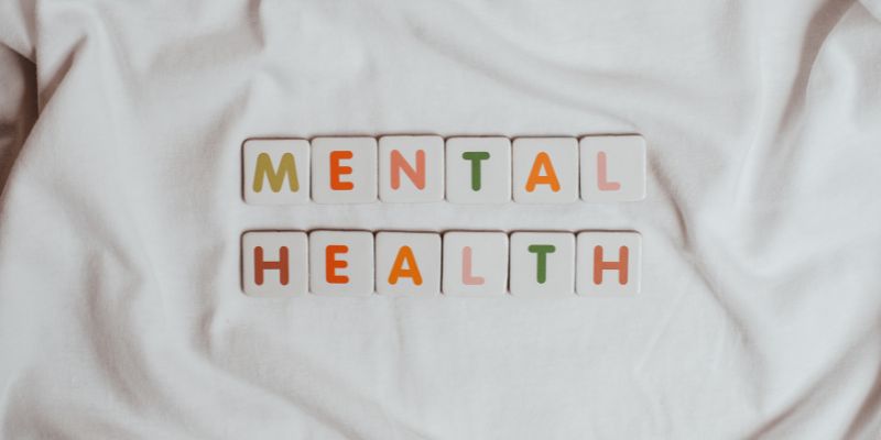 Tile spelling out 'Mental Health' n a white background. 