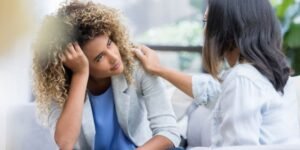 Image of two women, one consoling the other. Assessing mental health is key in this Mental Health in Primary Care course