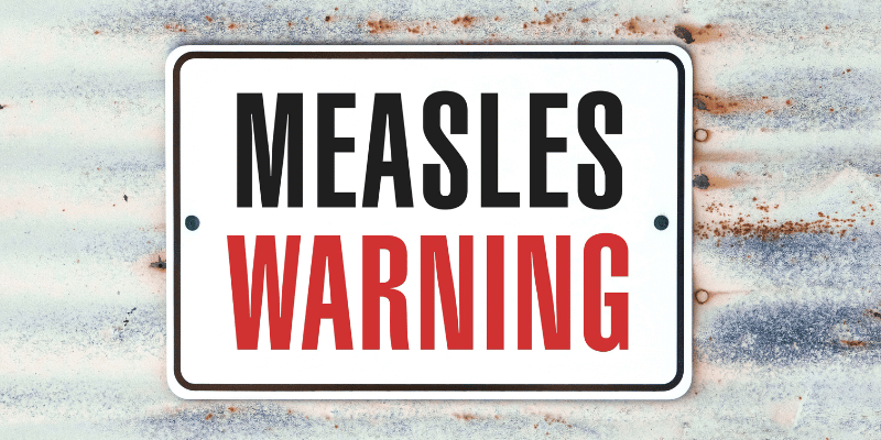 Image showing a sign saying Measles Warning. 
Measles outbreaks