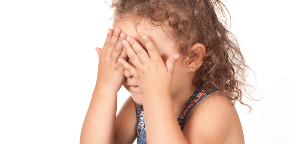 Image of a child covering her face.
Injecting children