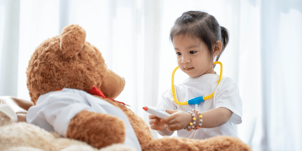 Image of a small child, role play as a nurse, injecting children