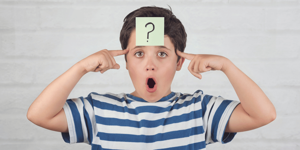 Image of a child with a question mark on his head.
