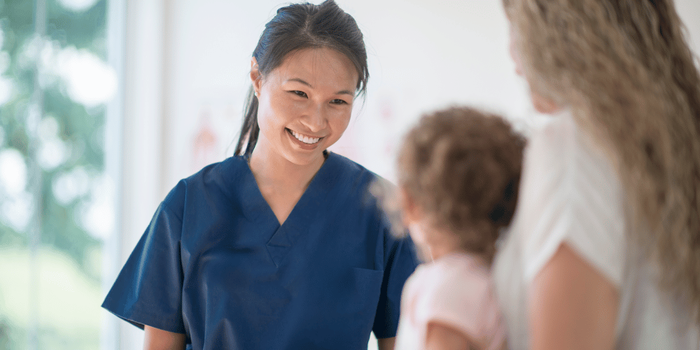 Image of a nurse with a child and her parent