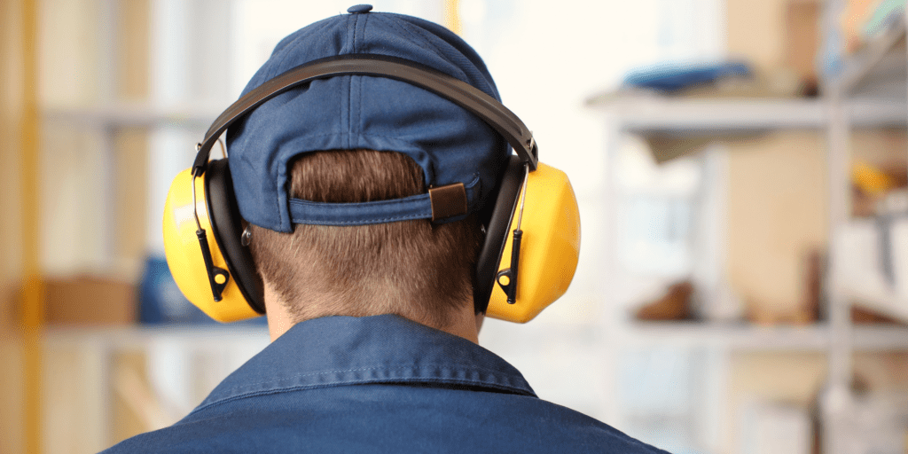 A man wearing ear defenders to ensure he is protected from loud noise