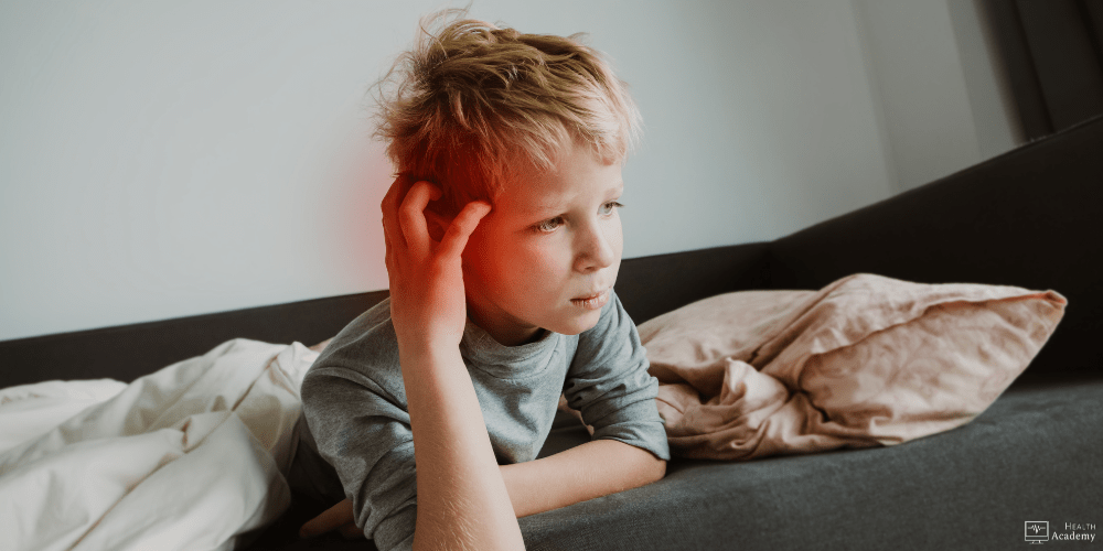 Image of boy holding head in pain.
Assessing pain in children.