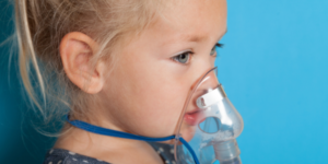 Image showing a child with an oxygen mask and a nebuliser for her asthma. Paediatric Asthma Update in Primary Care