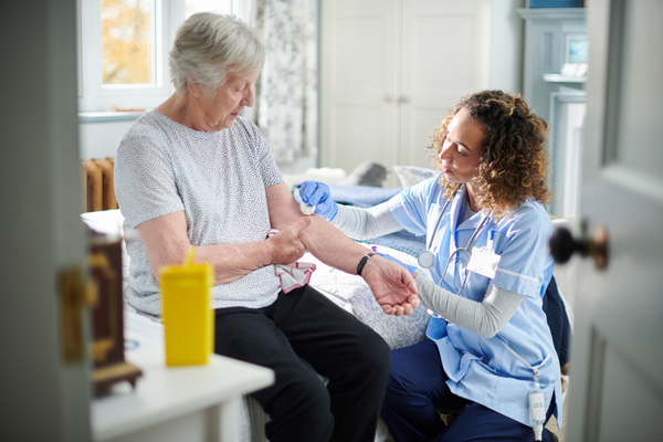Image showing Nurse in primary care giving post care after an injects of an elderly lady