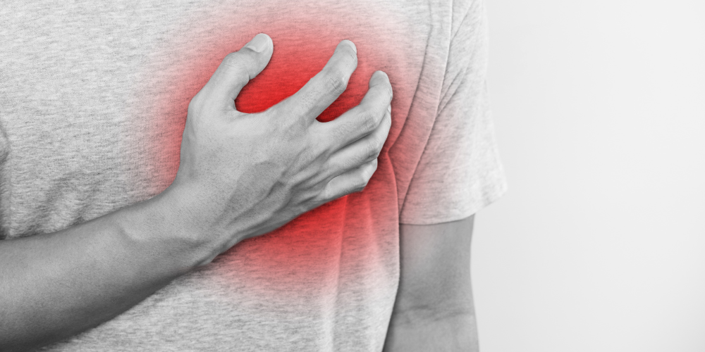 Image showing a person holding their left side of chest, depicting chest pain
Heart Month